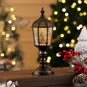 Detailed view of bronze Christmas street lamp snow globe with Santa and glowing water