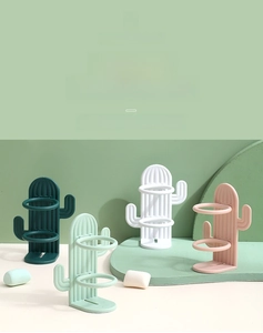 Set of four cactus-shaped toothbrush holders in white, pink, mint, and dark green