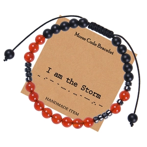 Handmade adjustable Morse Code bracelet with natural red agate beads on a display card