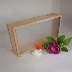 Detail of a rectangular natural wood frame with transparent acrylic panels for DIY dried flowers