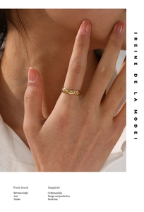 Detail of gold quilted motif ring on model showcasing refined metal texture and style
