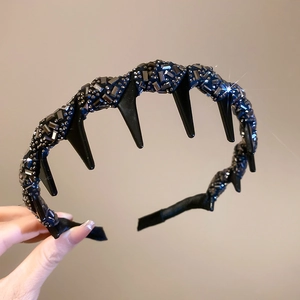 Detail of punk wavy headband with black rhinestones and sharp horn design accents