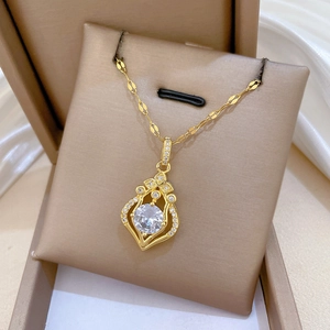 Macro shot of gold-plated drop pendant necklace with shimmering crystals on velvet