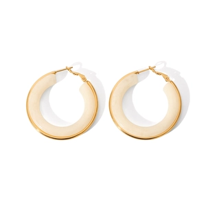 Detail of French vintage cream resin hoop earrings with elegant gold metal framing