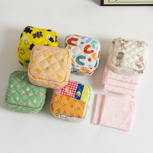 Flat lay of colorful quilted floral and animal pattern storage pouches for small items