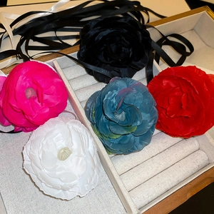 Lace fabric flower choker necklace in five colors displayed on jewelry box
