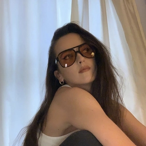Detail view of oversized pilot sunglasses with vintage double bridge and amber lenses