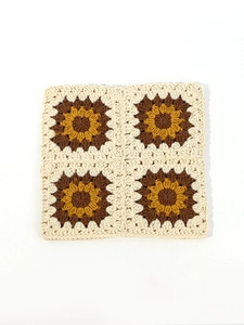 Detailed macro shot of the handmade sunflower crochet pattern with precise stitching