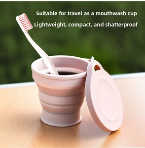 Pink collapsible silicone cup with lid shown in use as a portable travel rinse cup