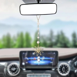 Golden sun-shaped car hanging ornament with pink gradient beads on rearview mirror
