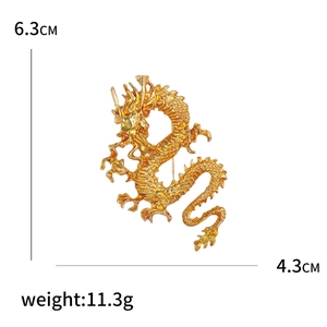 Golden enamel Chinese dragon brooch with dimensions 6.3cm x 4.3cm and weight 11.3g