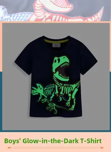 Detailed view of boys' navy blue cotton t-shirt featuring a green glow-in-the-dark dinosaur
