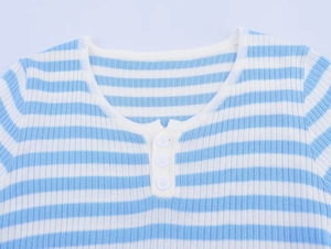 Detail of blue and white striped knit sweater showing ribbed crewneck and button closure
