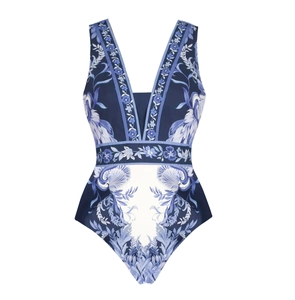 Detail of blue one-piece swimsuit with white floral prints and deep V-neckline