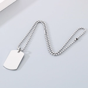 Polished silver military dog tag pendant with beaded chain on a clean neutral background