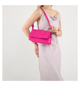 Detail of hot pink crossbody bag featuring quilted patterns and a knotted shoulder strap