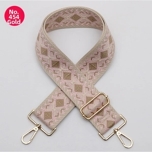 Close-up of bohemian geometric diamond pattern bag strap with gold metal lobster clasps