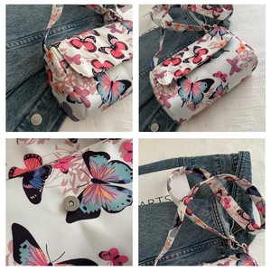 Detail of the butterfly print crossbody bag with magnetic buckle and adjustable strap