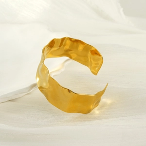 Detailed view of the hammered texture and organic wavy edges of the gold plated cuff bracelet