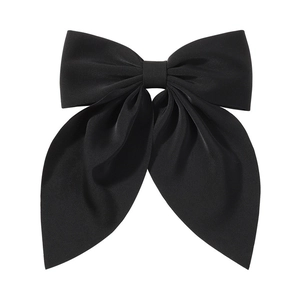 Close-up of a large black fabric bow hair clip with glossy texture and elegant drape