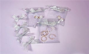 Silver mesh organza jewelry drawstring bags with glitter bow detail and earrings