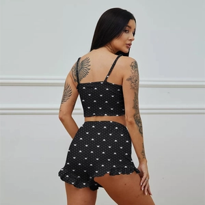 Back view of women's two-piece pajamas with white crown print and ruffled hem