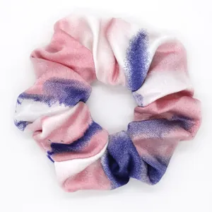 Colorful tie-dye fabric scrunchie with pink and blue watercolor pattern for women