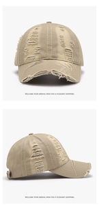 Close-up of khaki distressed cotton baseball cap with vintage frayed edges and holes
