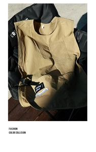 Detail view of khaki waterproof nylon apron with Tooling Wind pocket and side straps