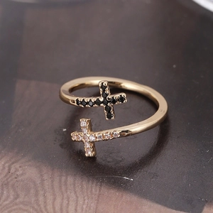 Elegant gold cross ring with black and white cubic zirconia in a minimalist open design
