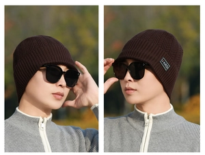 Detail of deep brown winter knit hat with thickened fleece lining and I FARDI logo patch