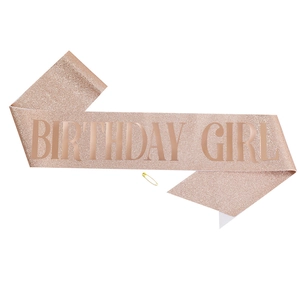 Detail of rose gold glitter Birthday Girl sash with a secure golden safety pin