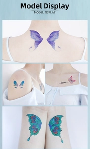 Detail of glitter butterfly temporary tattoos with freedom script on woman's skin