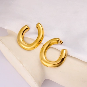 Close-up of polished 18k gold plated U-shape chunky earrings on an ear-shaped stand