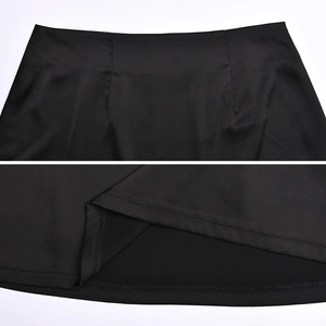 Detailed view of the black mini skirt's waistline and precise double-stitched hem texture