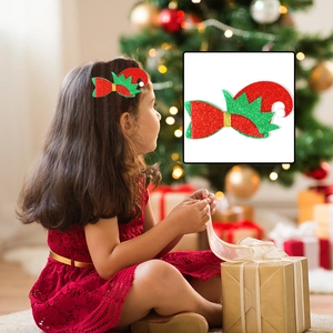 Close-up of a festive glittery Christmas elf hat hair clip on a little girl's head