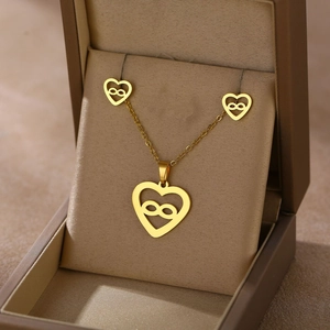 Golden heart necklace and earrings set with infinity symbol in a beige gift box