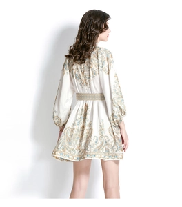 Rear view of white paisley print mini dress with lantern sleeves and back waist tailoring