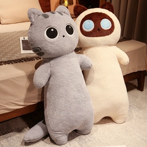 Detailed view of long cartoon cat plush pillows in gray and beige on a cozy bed