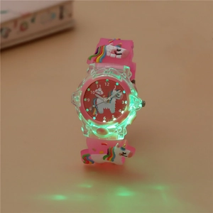 Luminous kids watch showing glowing green LED lights with pink unicorn silicone strap