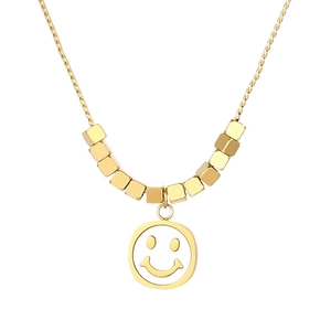Double-layered golden necklace featuring a smiley face pendant and geometric cube beads