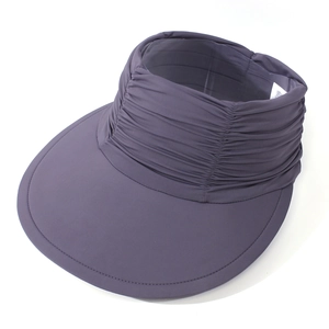 Detail view of ruched headband and wide brim on a dark gray cooling fabric sun visor