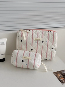 Detailed set of pink striped quilted cosmetic bags with star and heart patterns