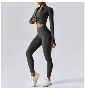 Side view of dark charcoal high-waisted yoga pants and slim jacket on fitness model