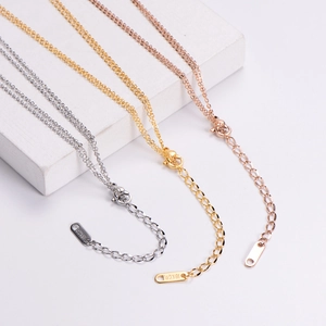 Detail of double-layer necklaces in silver, gold, and rose gold with 18KGP metal tags