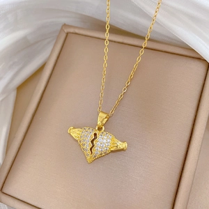 Macro shot of gold-plated broken heart pendant with micro-pave cubic zirconia crystals