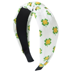 Knotted headband with green clover pattern on white fabric for St. Patrick's Day style