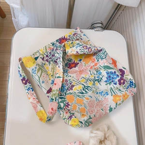 Close-up of a floral cotton tote bag with purple and yellow wildflower patterns