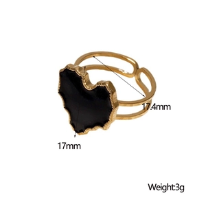 Detail view of adjustable gold ring featuring a 17mm black heart-shaped enamel charm