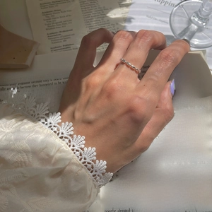 Detailed view of silver beaded adjustable chain ring with minimalist aesthetic on hand